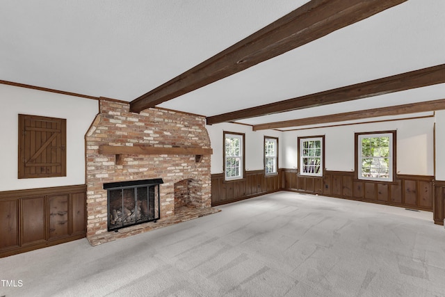 8121 Bentwood Pl, Raleigh, NC 27615 - unfurnished living room featuring wainscoting, carpet, beam ceiling, a brick fireplace, and wood walls