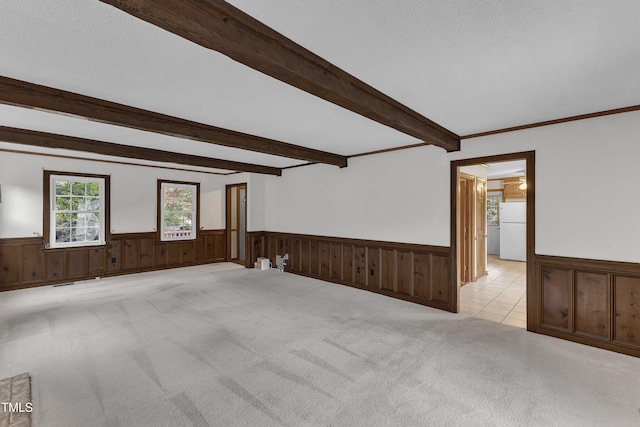 8121 Bentwood Pl, Raleigh, NC 27615 - empty room featuring wainscoting, beamed ceiling, and light colored carpet
