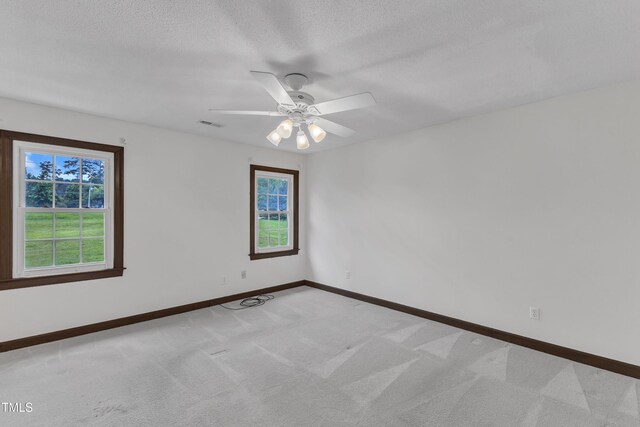 8121 Bentwood Pl, Raleigh, NC 27615 - unfurnished room featuring light carpet, baseboards, ceiling fan, and a textured ceiling