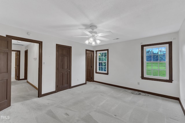 8121 Bentwood Pl, Raleigh, NC 27615 - unfurnished bedroom with light colored carpet, baseboards, ceiling fan, and a textured ceiling