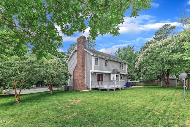 8121 Bentwood Pl, Raleigh, NC 27615 - rear view of house featuring a chimney, a deck, and cooling unit