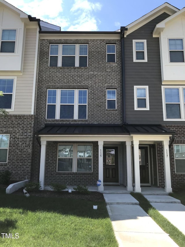 115 Ballyliffen Ln, Cary, NC 27519 - multi unit property with brick siding, a standing seam roof, and a front lawn