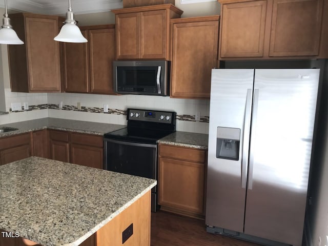 115 Ballyliffen Ln, Cary, NC 27519 - kitchen featuring stainless steel appliances, light stone countertops, backsplash, dark wood-style floors, and brown cabinetry