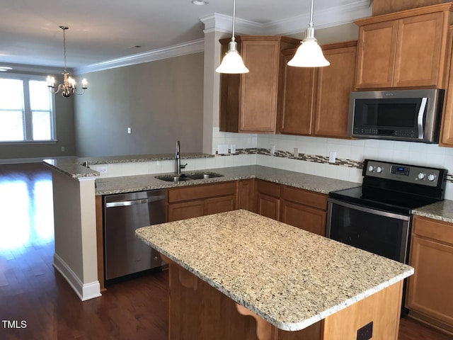 115 Ballyliffen Ln, Cary, NC 27519 - kitchen featuring appliances with stainless steel finishes, a sink, dark wood finished floors, a peninsula, and a chandelier