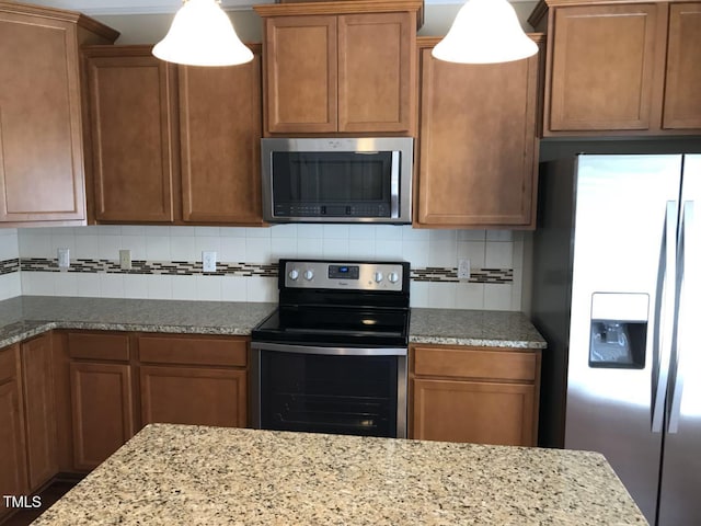 115 Ballyliffen Ln, Cary, NC 27519 - kitchen with stainless steel appliances, tasteful backsplash, light stone counters, and brown cabinets