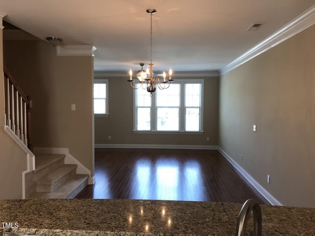 115 Ballyliffen Ln, Cary, NC 27519 - unfurnished dining area with crown molding, stairs, baseboards, dark wood-style flooring, and a chandelier