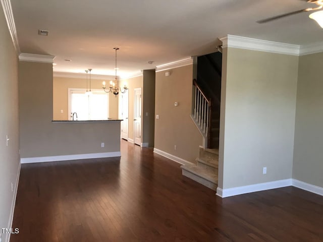 115 Ballyliffen Ln, Cary, NC 27519 - unfurnished living room with ornamental molding, a chandelier, dark wood-style flooring, stairs, and baseboards