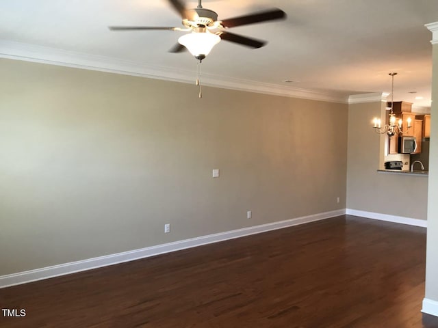 115 Ballyliffen Ln, Cary, NC 27519 - spare room with ornamental molding, dark wood-style flooring, a chandelier, ceiling fan, and baseboards