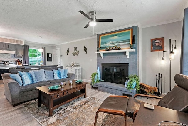 9872 NC-72 Hwy E, Lumberton, NC 28358 - living area with light wood-style flooring, a textured ceiling, a ceiling fan, a brick fireplace, and crown molding