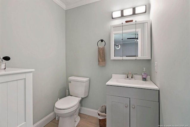 9872 NC-72 Hwy E, Lumberton, NC 28358 - bathroom featuring vanity, toilet, baseboards, and ornamental molding