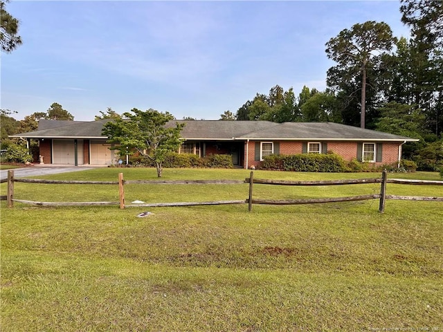 815 Whispering Pines Rd, Fayetteville, NC 28311 - ranch-style home with brick siding, an attached garage, concrete driveway, and a front yard