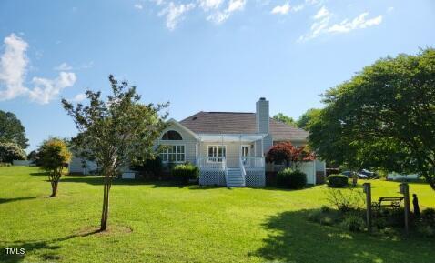 3409 Bennyfield Ct, Fuquay Varina, NC 27526 - rear view of property featuring a yard and a chimney