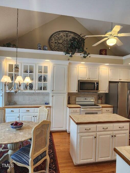 3409 Bennyfield Ct, Fuquay Varina, NC 27526 - kitchen with stainless steel appliances, light countertops, white cabinets, backsplash, and a chandelier