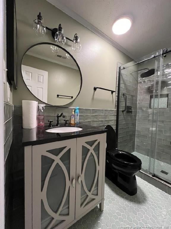 707 Connaly Dr, Hope Mills, NC 28348 - bathroom featuring tile walls, tile patterned flooring, vanity, a stall shower, and crown molding