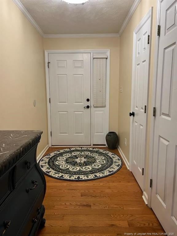 707 Connaly Dr, Hope Mills, NC 28348 - entryway with wood finished floors, ornamental molding, and baseboards