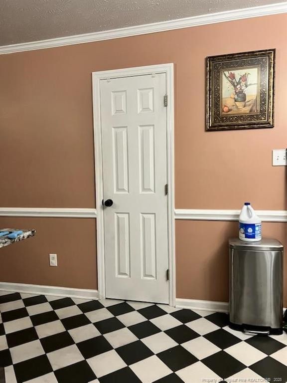 707 Connaly Dr, Hope Mills, NC 28348 - empty room featuring tile patterned floors, baseboards, ornamental molding, and a textured ceiling