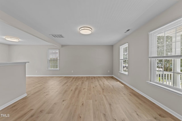 5012 Silverdene St, Raleigh, NC 27616 - unfurnished living room featuring light wood finished floors, healthy amount of natural light, and baseboards