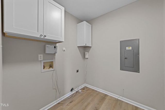 5012 Silverdene St, Raleigh, NC 27616 - laundry area with electric panel, baseboards, light wood-style flooring, cabinet space, and hookup for a washing machine