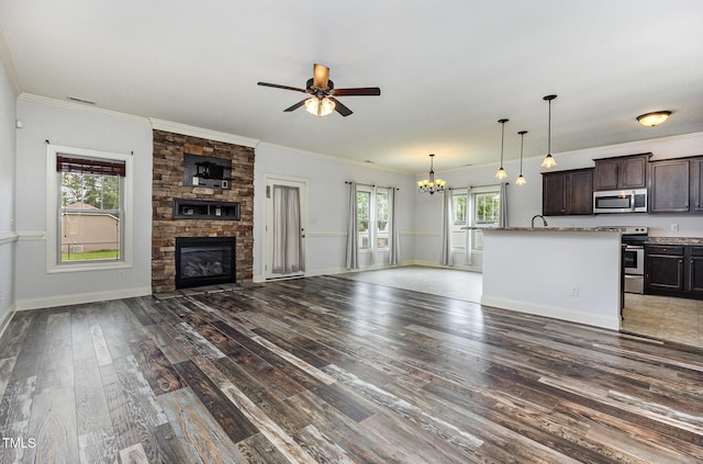 235 Camden Place St, Princeton, NC 27569 - unfurnished living room with a chandelier, a fireplace, dark wood-style flooring, a ceiling fan, and ornamental molding