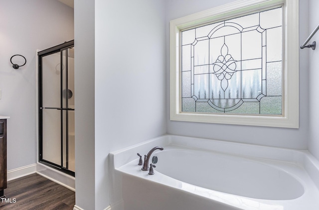 235 Camden Place St, Princeton, NC 27569 - full bathroom featuring a bath, a shower stall, wood finished floors, and baseboards