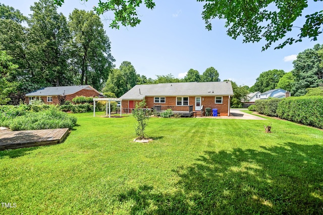 5 Windsor Pl, Mebane, NC 27302 - rear view of house featuring brick siding, a deck, and a yard
