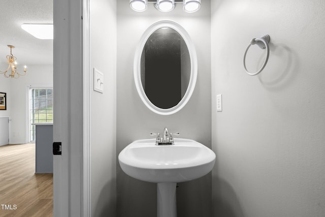5332 Seaspray Ln, Raleigh, NC 27610 - bathroom with wood finished floors and a chandelier