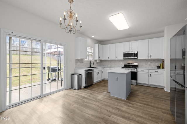 5332 Seaspray Ln, Raleigh, NC 27610 - kitchen featuring stainless steel appliances, light countertops, backsplash, wood finished floors, and recessed lighting