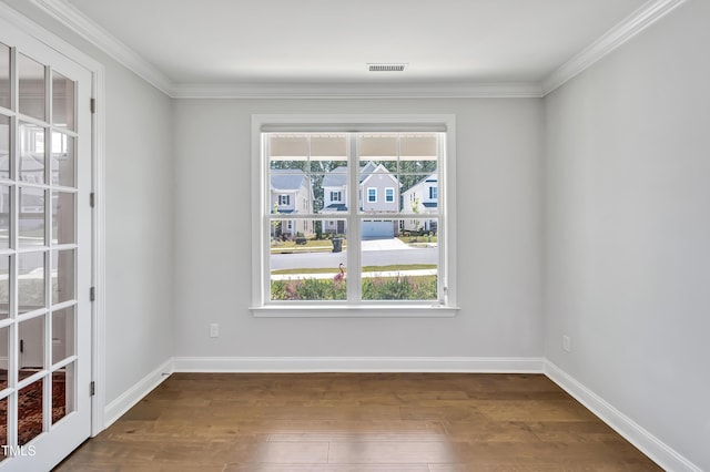 121 Canyon Gap Way, Raleigh, NC 27610 - spare room featuring dark wood-style flooring, baseboards, and crown molding