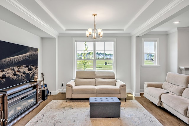 121 Canyon Gap Way, Raleigh, NC 27610 - living area with a tray ceiling, a chandelier, wood finished floors, baseboards, and crown molding