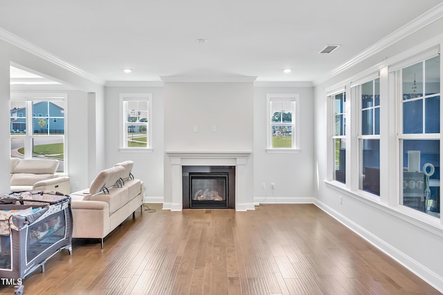 121 Canyon Gap Way, Raleigh, NC 27610 - living room with a glass covered fireplace, hardwood / wood-style flooring, crown molding, baseboards, and recessed lighting