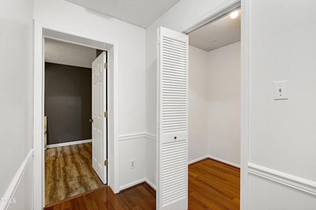 1416 Bramble Dr, Durham, NC 27712 - hallway featuring wood finished floors and a textured ceiling