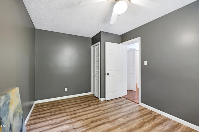 1416 Bramble Dr, Durham, NC 27712 - unfurnished bedroom featuring wood finished floors, a closet, baseboards, and a textured ceiling