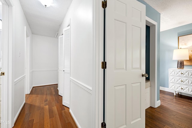 1416 Bramble Dr, Durham, NC 27712 - corridor featuring a textured ceiling, wood finished floors, and baseboards