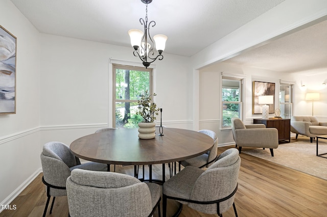1416 Bramble Dr, Durham, NC 27712 - dining room featuring light wood-type flooring, a chandelier, and baseboards