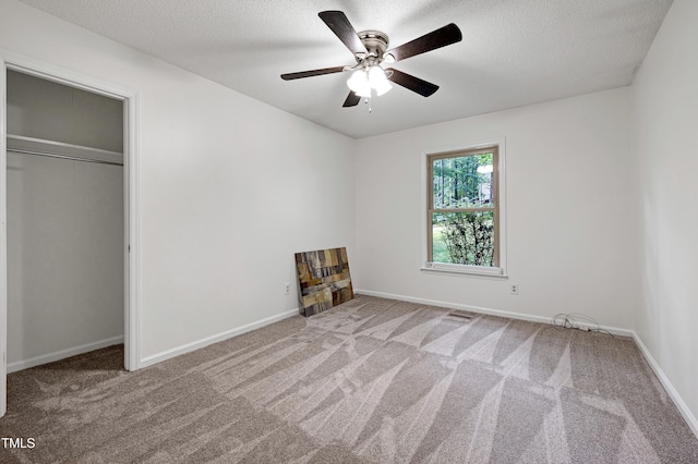 1416 Bramble Dr, Durham, NC 27712 - unfurnished bedroom featuring a textured ceiling, carpet, baseboards, ceiling fan, and a closet