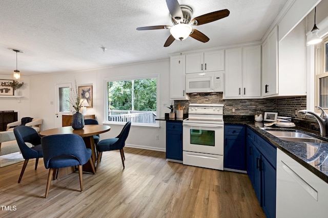 1416 Bramble Dr, Durham, NC 27712 - kitchen with white appliances, blue cabinets, light wood-type flooring, a sink, and white cabinets