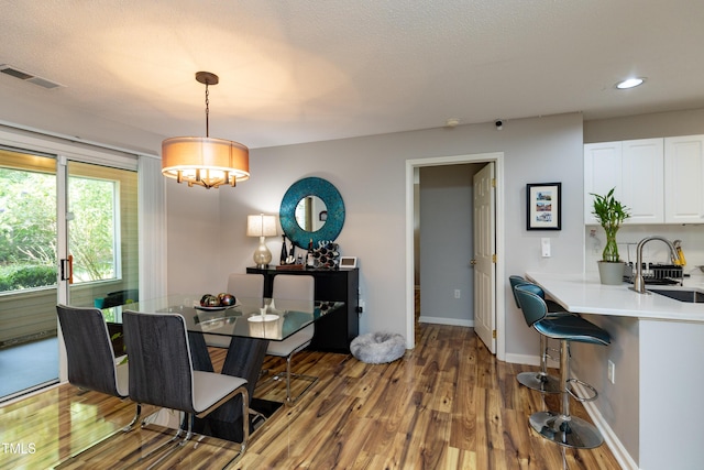 1911 Falls Landing Dr Unit 103, Raleigh, NC 27614 - dining area with wood finished floors, a chandelier, recessed lighting, and baseboards
