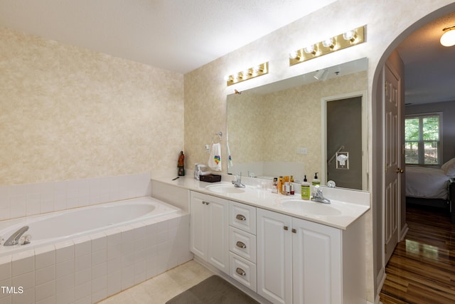 1911 Falls Landing Dr Unit 103, Raleigh, NC 27614 - full bathroom featuring a bath, double vanity, connected bathroom, and wallpapered walls