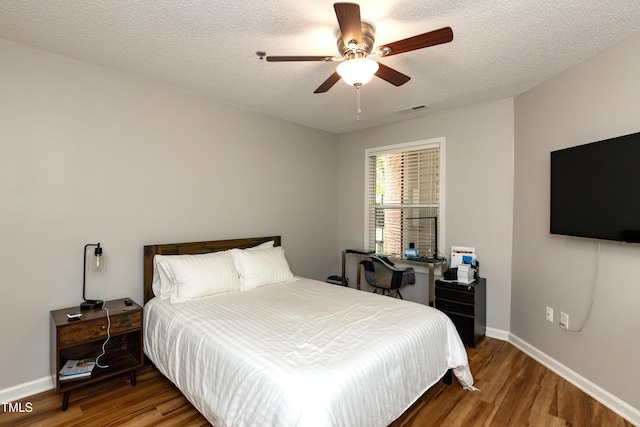 1911 Falls Landing Dr Unit 103, Raleigh, NC 27614 - bedroom with wood finished floors, baseboards, ceiling fan, and a textured ceiling
