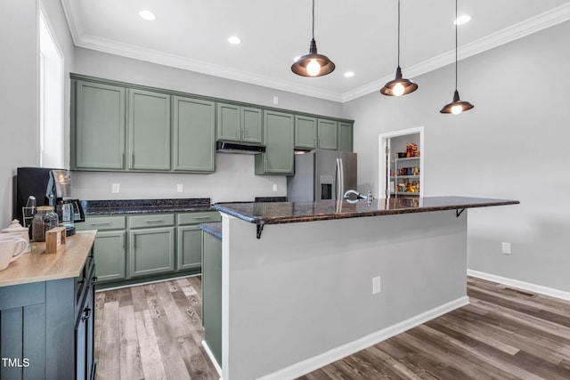 80 Shartree Farms Ln, Louisburg, NC 27549 - kitchen featuring stainless steel fridge, green cabinets, under cabinet range hood, wood finished floors, and crown molding
