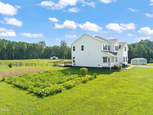 80 Shartree Farms Ln, Louisburg, NC 27549 - view of property exterior featuring an outdoor structure, a lawn, a porch, and a garage