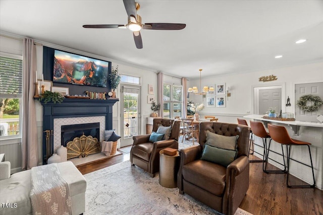 817 Mossy Oak Dr, Fuquay Varina, NC 27526 - living room featuring wood finished floors, crown molding, ceiling fan, a fireplace, and recessed lighting