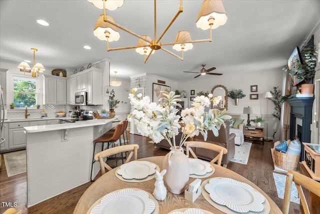 817 Mossy Oak Dr, Fuquay Varina, NC 27526 - dining room featuring a chandelier, wood finished floors, recessed lighting, and ceiling fan