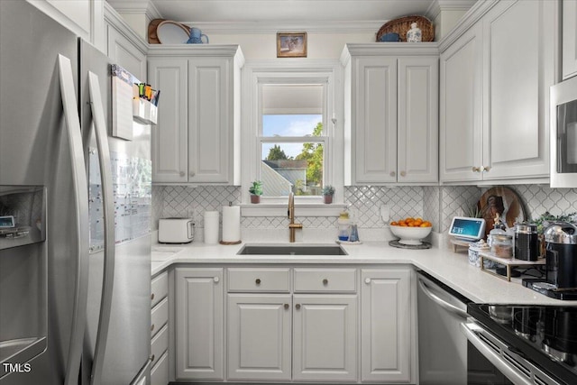 817 Mossy Oak Dr, Fuquay Varina, NC 27526 - kitchen featuring appliances with stainless steel finishes, a sink, decorative backsplash, crown molding, and light countertops