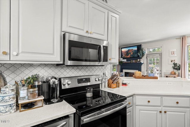 817 Mossy Oak Dr, Fuquay Varina, NC 27526 - kitchen with stainless steel appliances, backsplash, light countertops, and white cabinetry