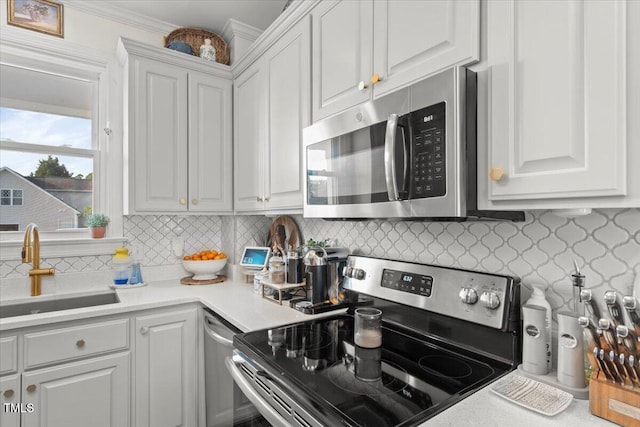 817 Mossy Oak Dr, Fuquay Varina, NC 27526 - kitchen featuring appliances with stainless steel finishes, a sink, white cabinets, backsplash, and light countertops