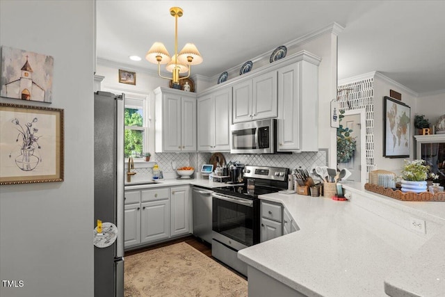 817 Mossy Oak Dr, Fuquay Varina, NC 27526 - kitchen featuring appliances with stainless steel finishes, ornamental molding, backsplash, light countertops, and pendant lighting