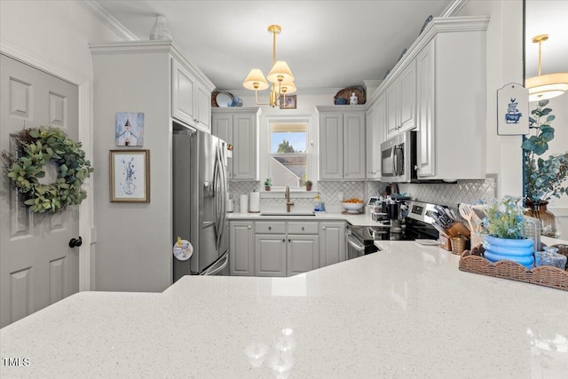 817 Mossy Oak Dr, Fuquay Varina, NC 27526 - kitchen with appliances with stainless steel finishes, a sink, decorative backsplash, decorative light fixtures, and light stone counters