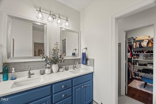 817 Mossy Oak Dr, Fuquay Varina, NC 27526 - bathroom featuring double vanity, tasteful backsplash, and a spacious closet