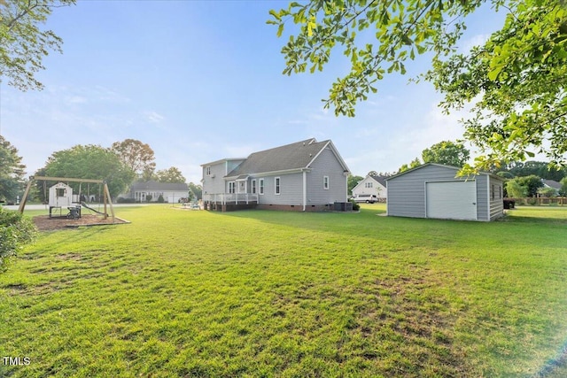 817 Mossy Oak Dr, Fuquay Varina, NC 27526 - view of grassy yard with a garage, an outbuilding, and cooling unit